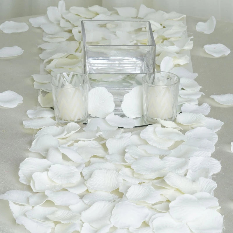 Ivory silk rose petals for wedding decor, scattered around clear containers