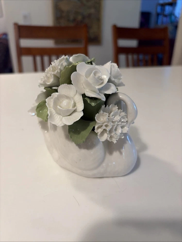White hand-painted swan-shaped bone china bouquet with white flowers and green leaves