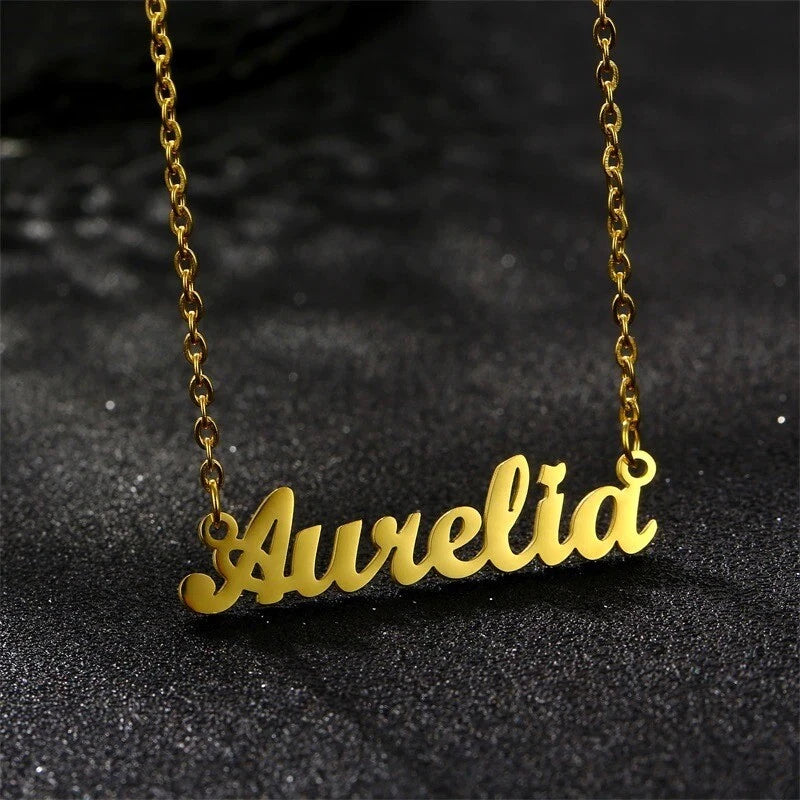 Gold-tone name pendant necklace with cursive personalized charm on a chain