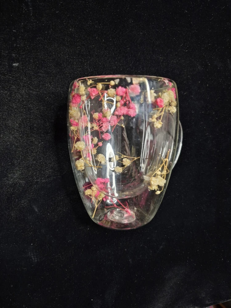 Double-wall clear glass mug with dried pink botanical flowers inside