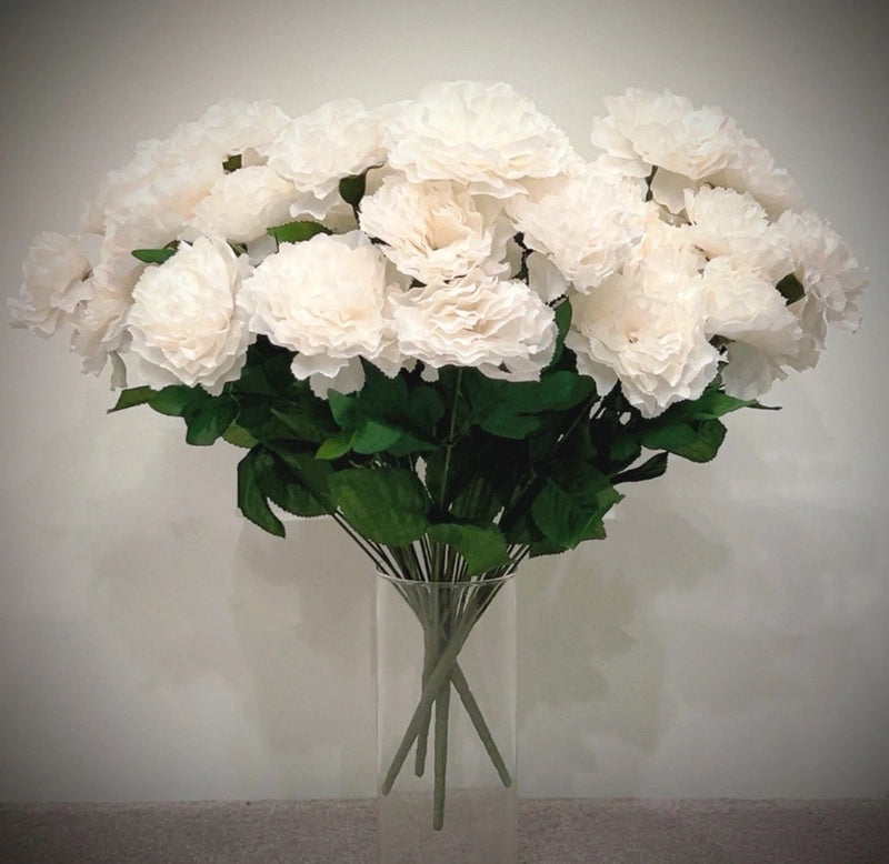 Cream artificial carnation bush with clustered blooms and green leaves, set in a bouquet
