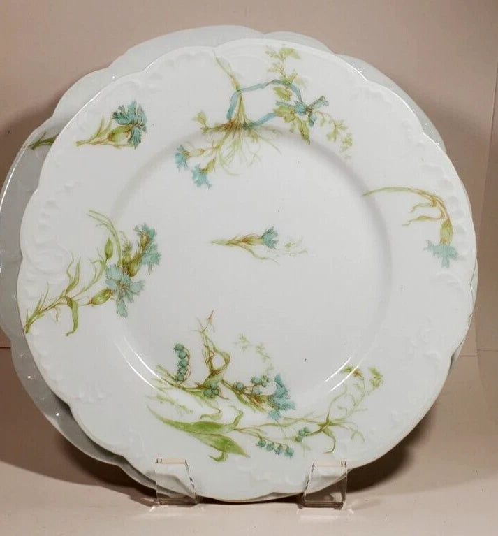 Turquoise floral dinner plate with green leaves on white porcelain, round rim
