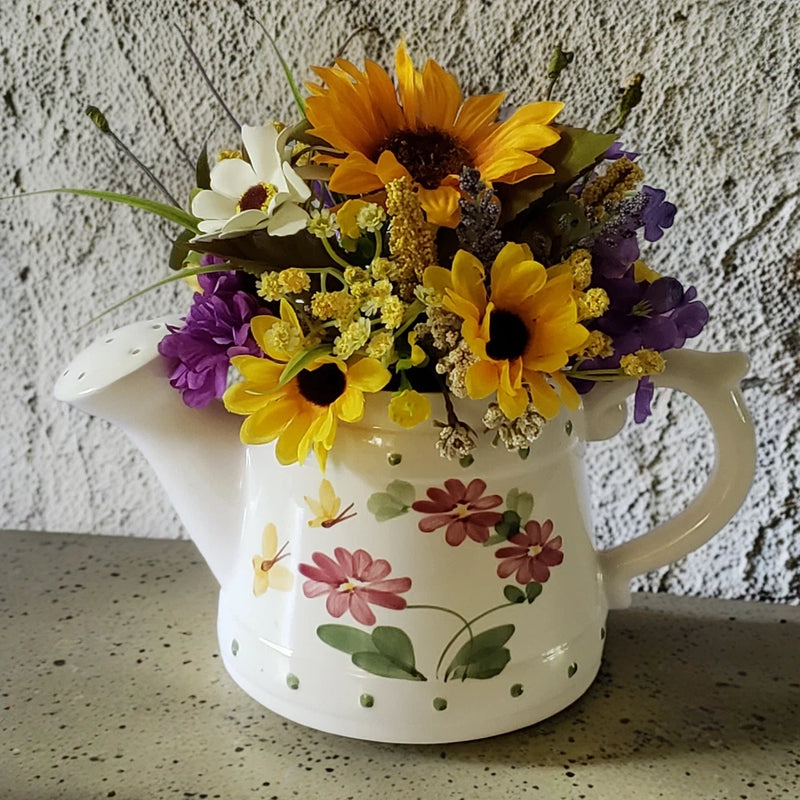 Hand-painted ceramic water can centerpiece with sunflower floral bouquet, white base