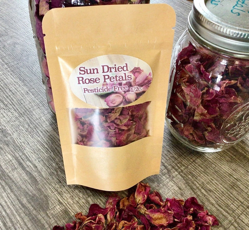 Sun-dried rose petals in kraft paper pouch, loose dried petals shown