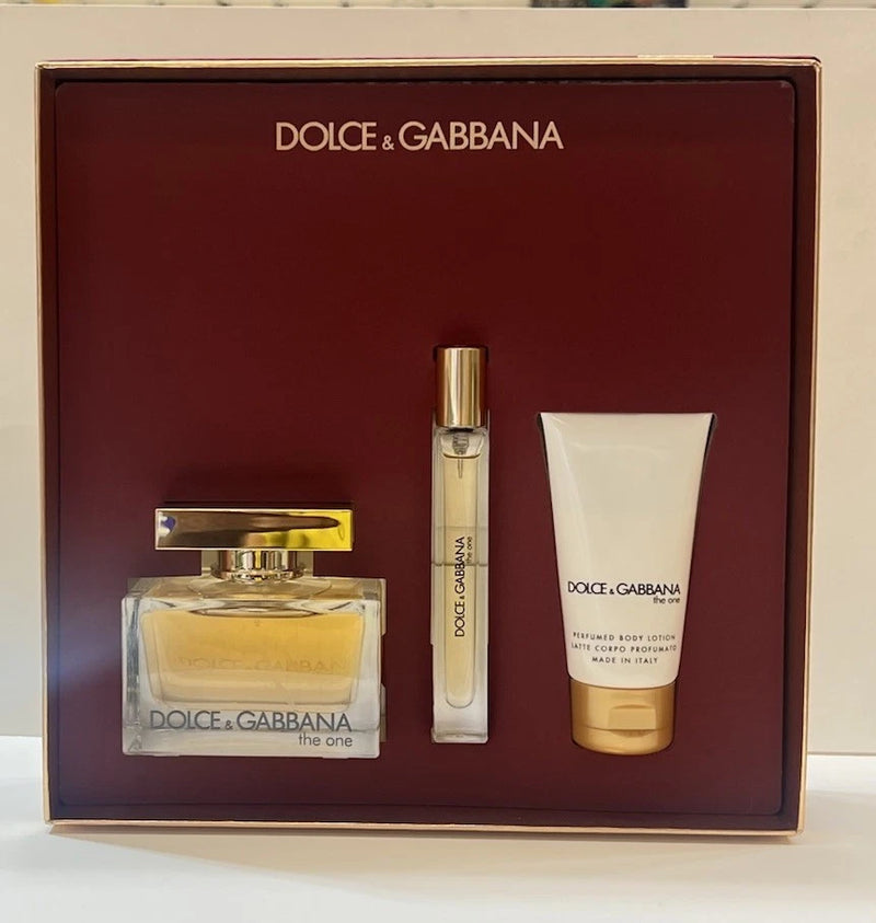 Fragrance gift set with gold atomizer spray, slim vial, and white body lotion