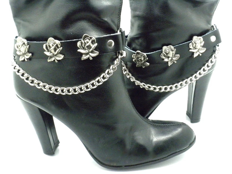 Black boot straps with rose metal flowers, chain detail, and buckle closure on heels