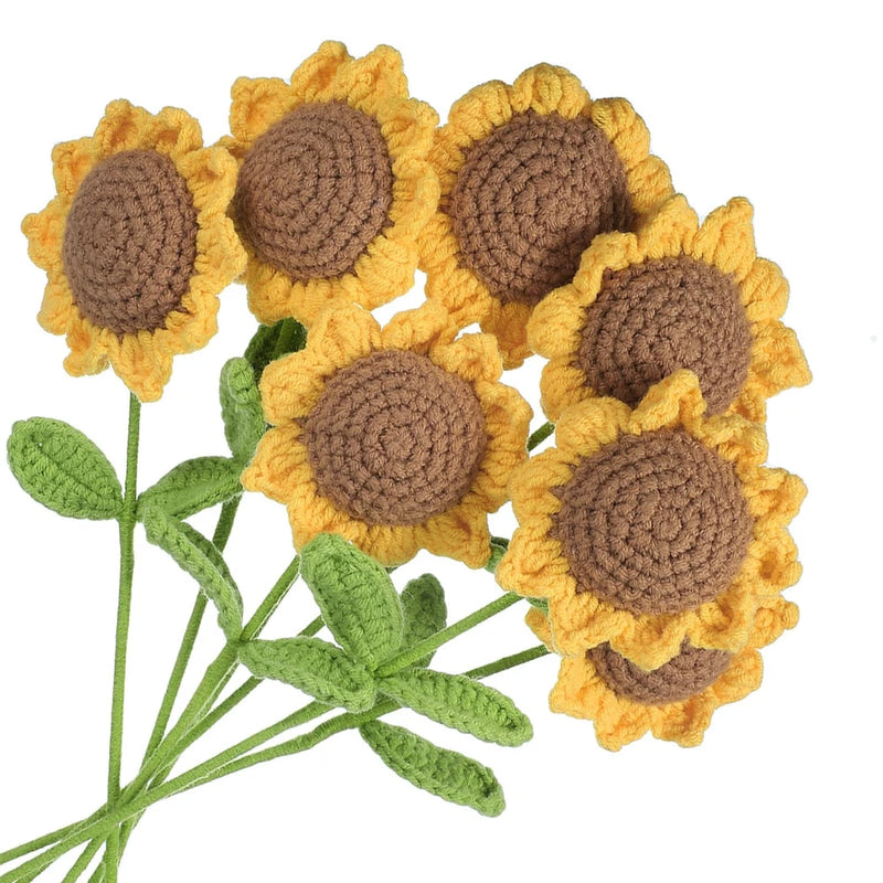 Crocheted sunflower artificial flowers with brown centers and yellow petals on green stems
