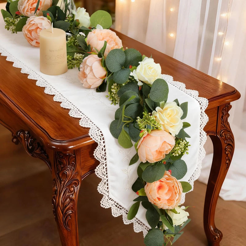 Faux eucalyptus floral garland with peach and white flowers and green leaves
