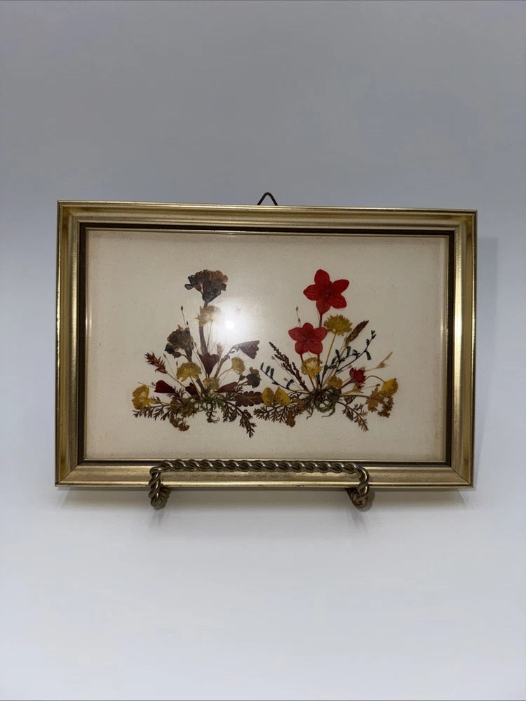 Vintage dried floral picture with red and brown pressed flowers in gold-tone frame
