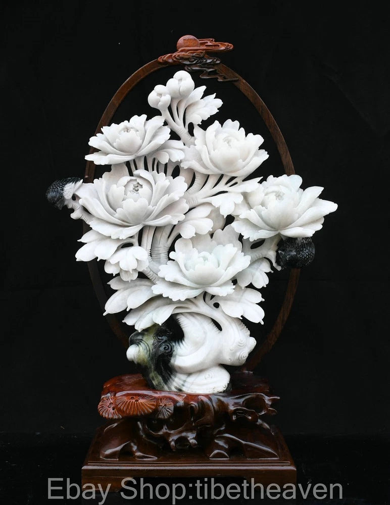 White jade peony flower carving statue with floral relief and ornate dark base