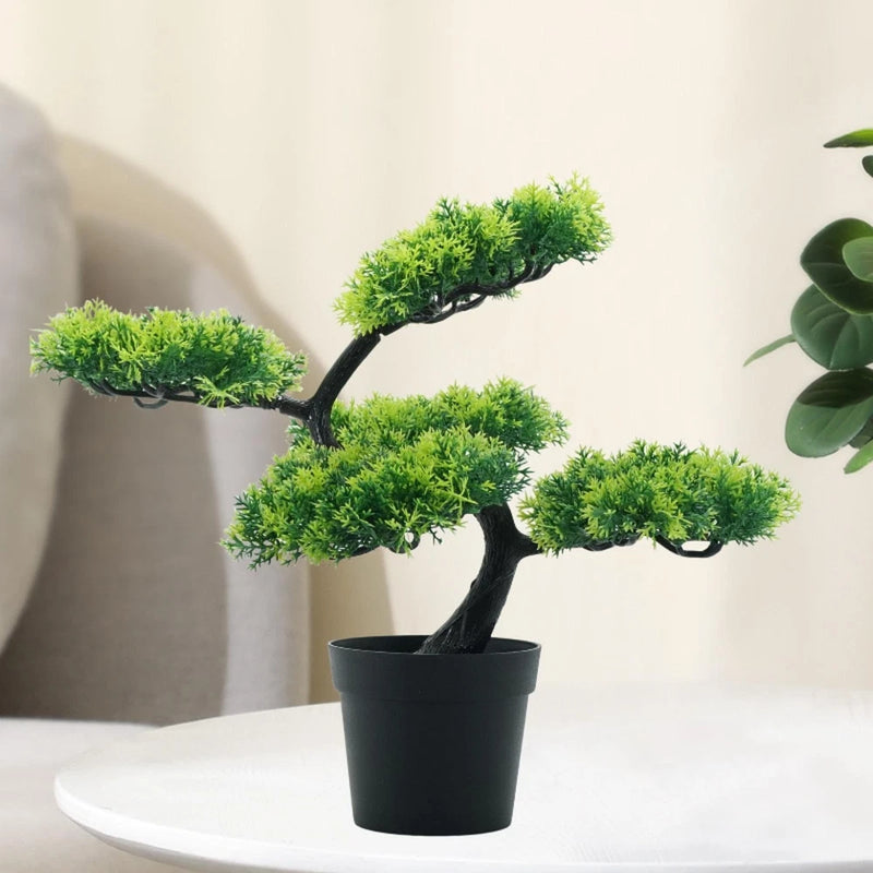 Artificial bonsai tree with bright green foliage in a black pot