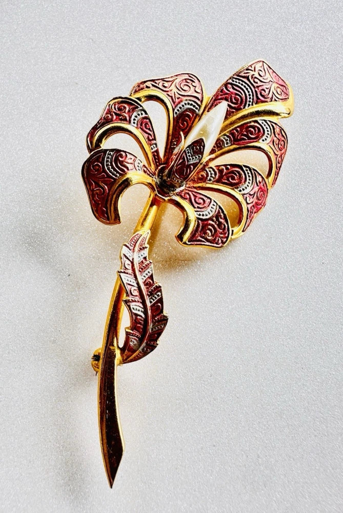 Gold-tone enamel lily brooch with maroon swirl details and faux pearl accents