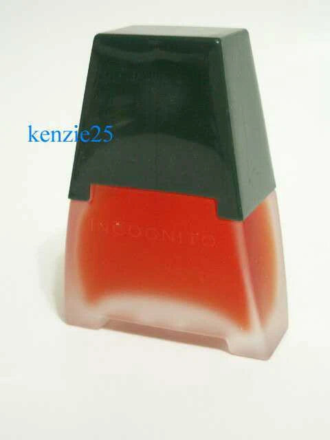 Perfume spray bottle with dark green cap and translucent orange glass