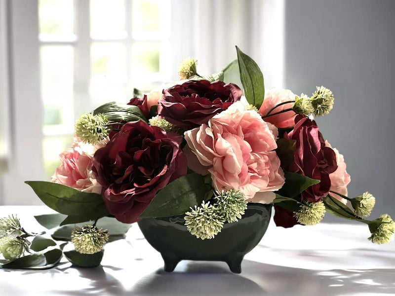 Peony floral arrangement in dark sage green planter with burgundy and blush blooms