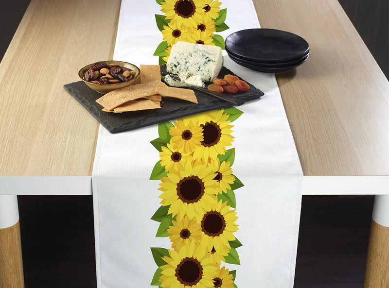 White table runner with sunflower garland border and yellow flowers with dark centers