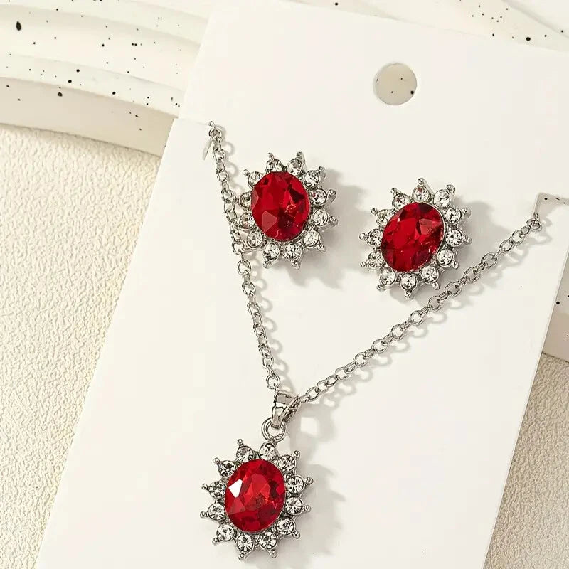 Silver-tone jewelry set with red round gemstone sunflower medallions and matching earrings
