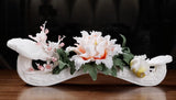 White porcelain ruyi statue with peony flowers and green leaves