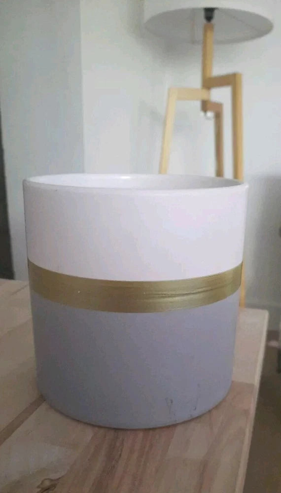 Two-tone ceramic planter pot with white top and gold band, light gray base