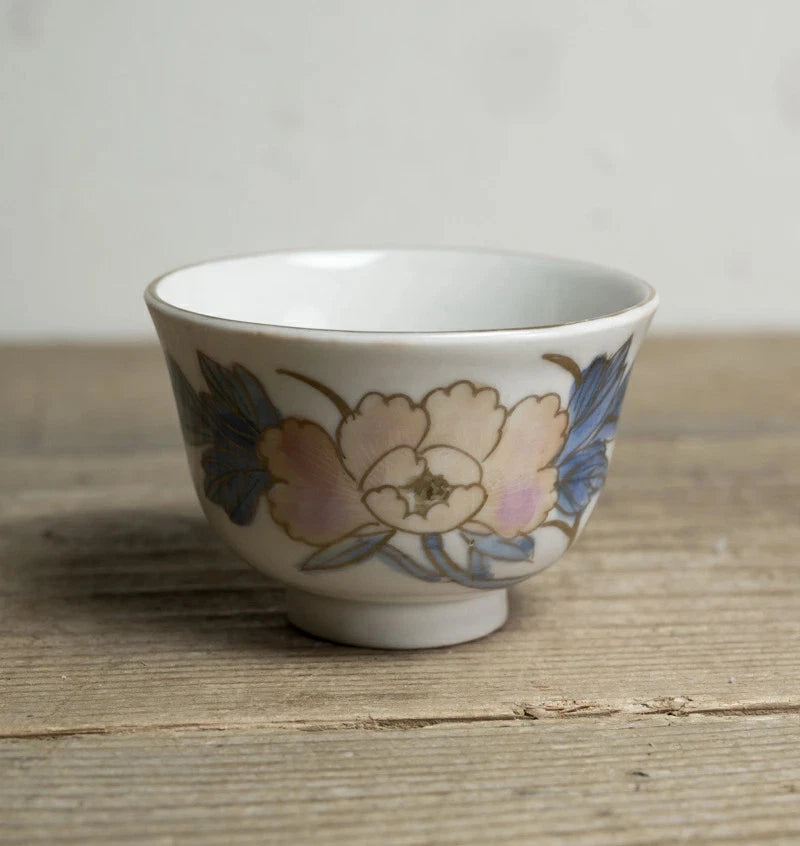 Porcelain sake cup with peony flower and blue pattern, curved bowl shape