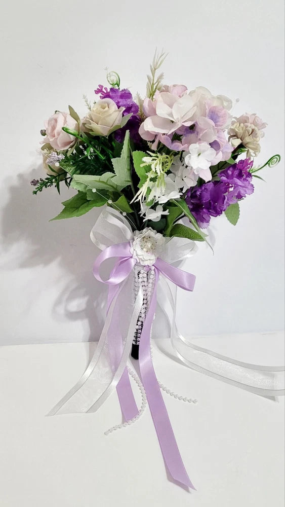 Wedding bouquet. Artificial flowers accessory with pearls and ribbons Bouquet