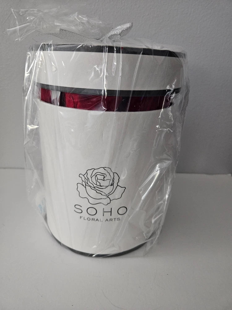 White round preserved-rose box with red roses, sealed in clear plastic wrap