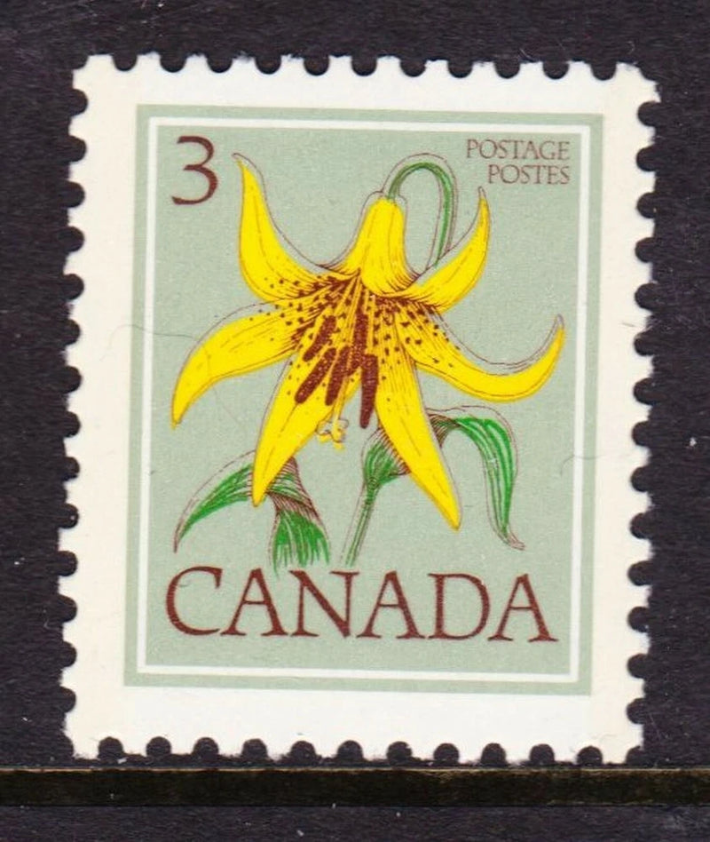 Canada postage stamp featuring a yellow Canada lily flower on mint background