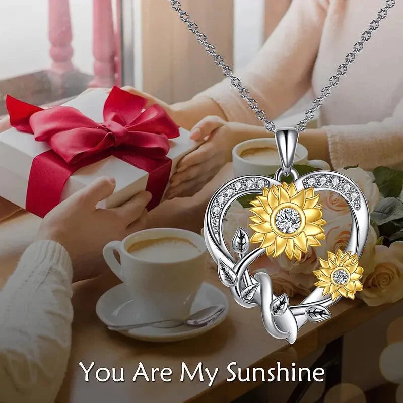 Silver-tone heart pendant necklace with sunflower and rhinestone center, on chain
