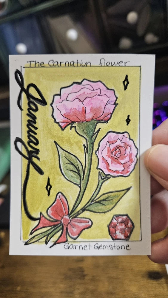 Greeting card with illustrated pink carnation flowers and red garnet gemstone