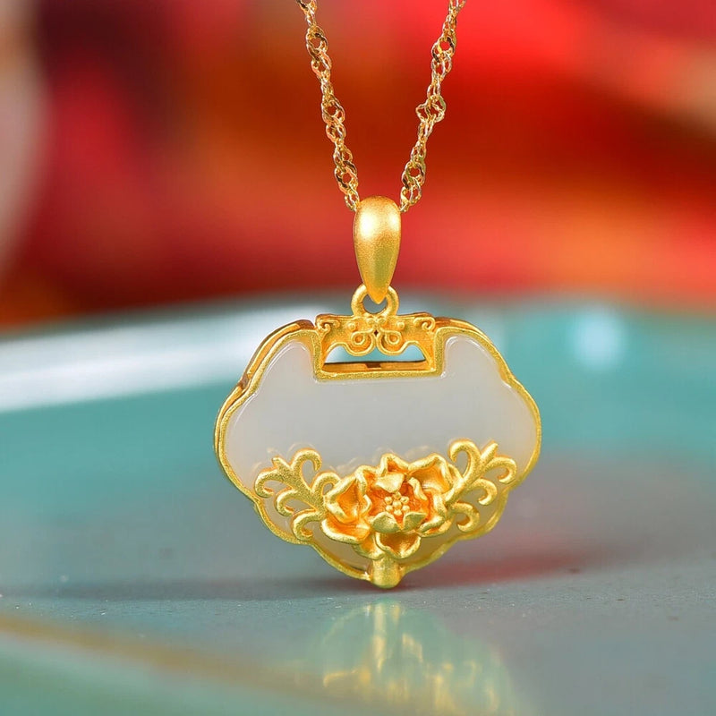 Gold-tone pendant necklace with white inlay and peony flower carved charm