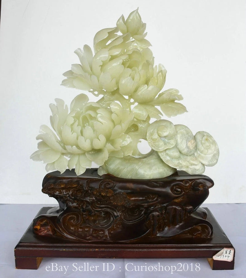 Light jade peony and ganoderma sculpture on ornate dark wood base