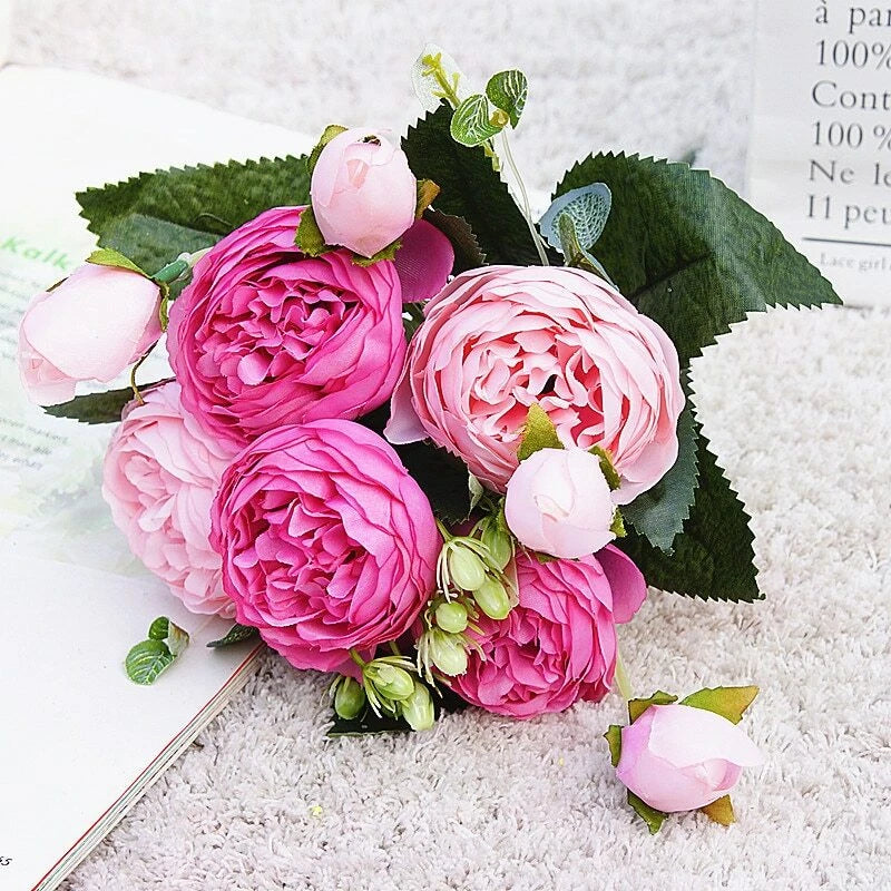 Small artificial silk peony bouquet with pink and light-pink blooms and green leaves