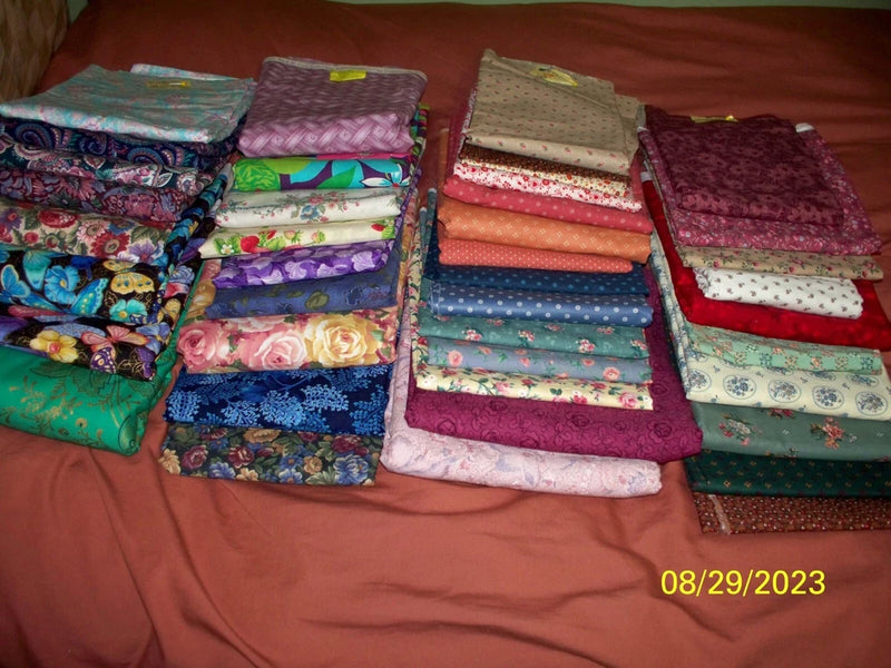 Cotton quilting fabric bundle with multicolor floral prints and folded fabric squares
