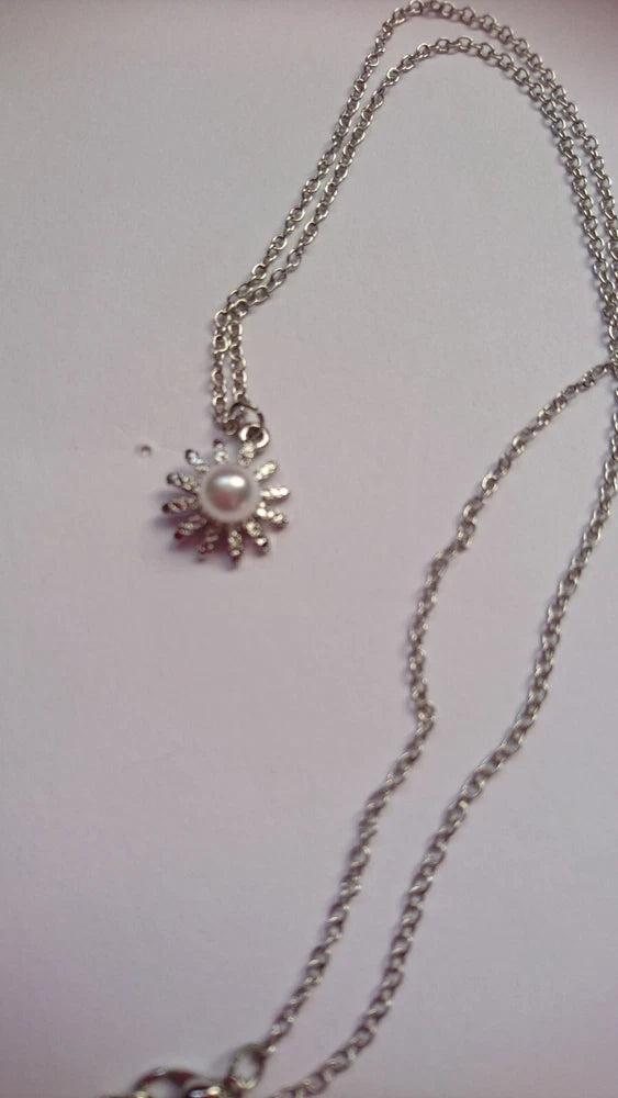 Silver plated sunflower pendant necklace with pearl-like center and gem accents