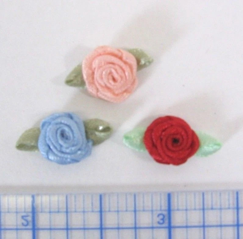 Tiny satin rolled rose ribbon embellishments: pink, blue, red roses with green leaves