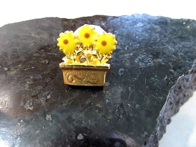 Yellow enamel sunflower lapel pin in a window box with gold-tone backing
