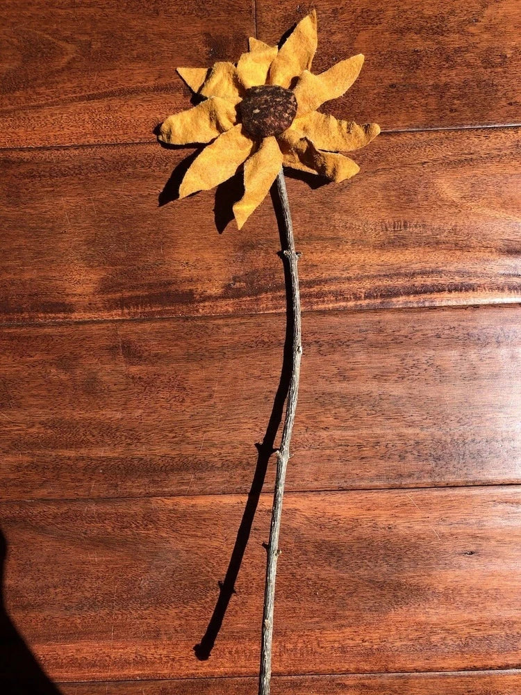 Handmade sunflower on a stick with yellow petals and dark brown center