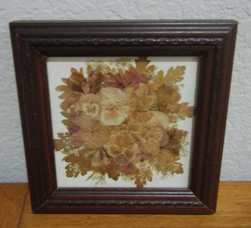 Square framed pressed flower wall art with dried beige and brown flowers, dark brown frame