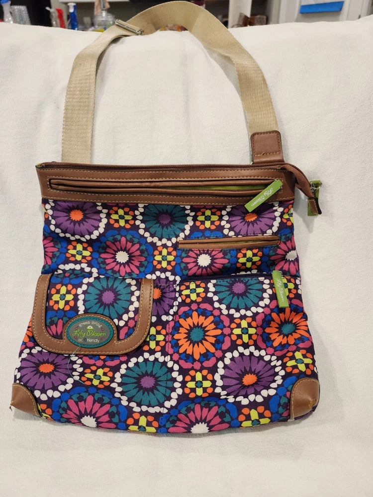 Boho crossbody bag with multicolor floral print, brown trim, front zipper pocket