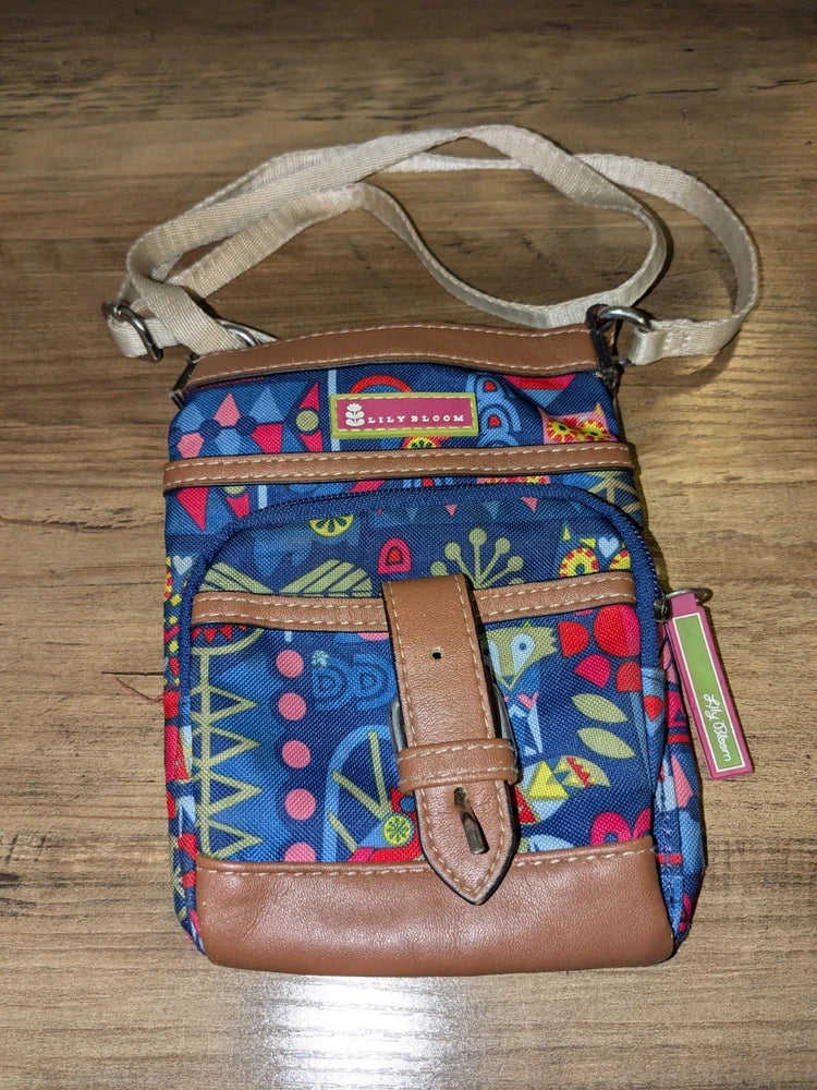 Small Lily Bloom crossbody purse with colorful illustrated pattern, brown leather buckle strap