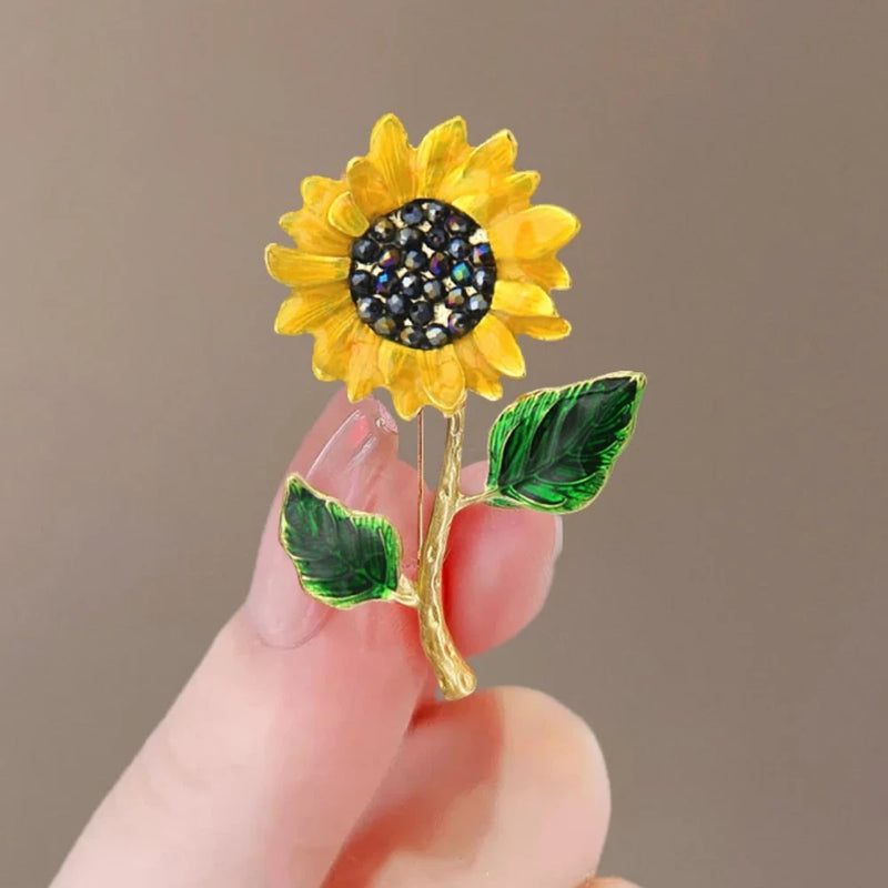 Sunflower rhinestone brooch pin with yellow petals, black crystal center, gold tone stem