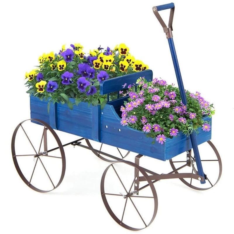 Blue wooden wagon planter with four wheels, filled with colorful flowers and greenery