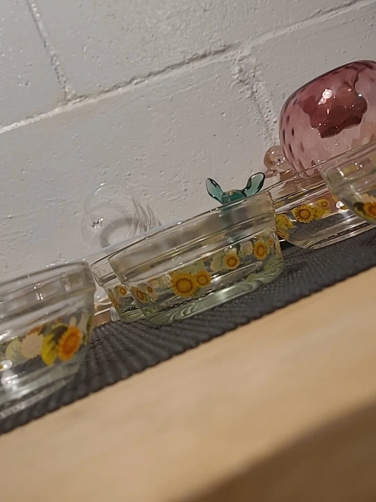 Clear glass bowl set with sunflower print, decorative flower-shaped accents