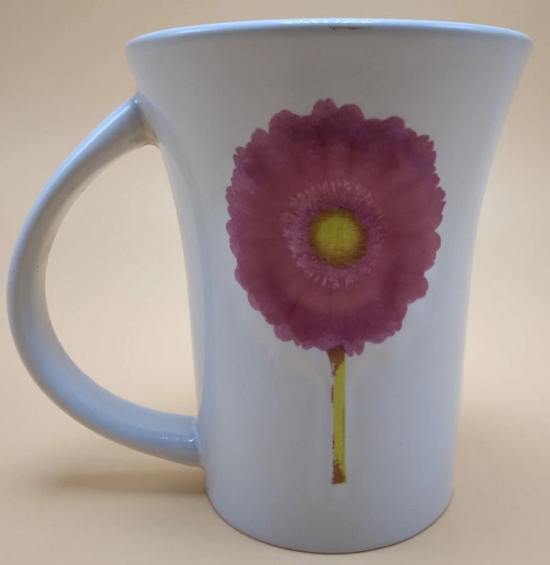 White coffee mug with pink carnation flower graphic and curved handle