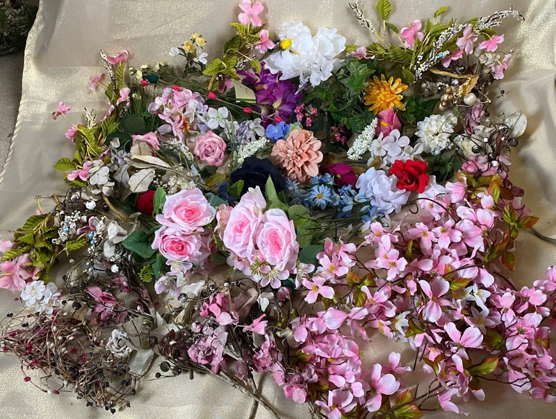 Artificial spring flower bouquet with pink roses, cherry blossoms, and green foliage