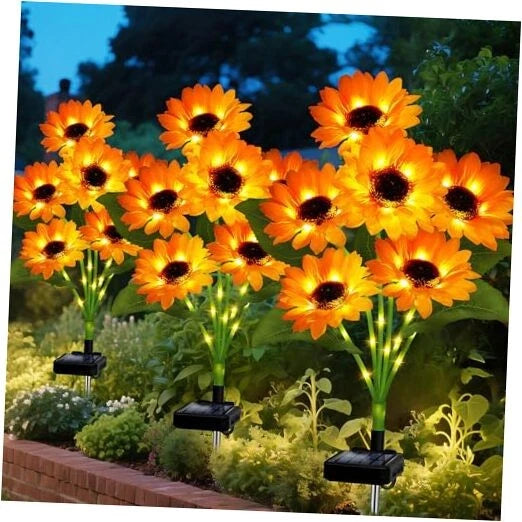 Solar sunflower garden stake lights with warm glowing bulbs on black stakes