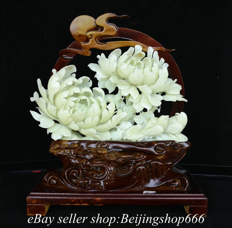 White jade peony and bird carving on dark wooden base