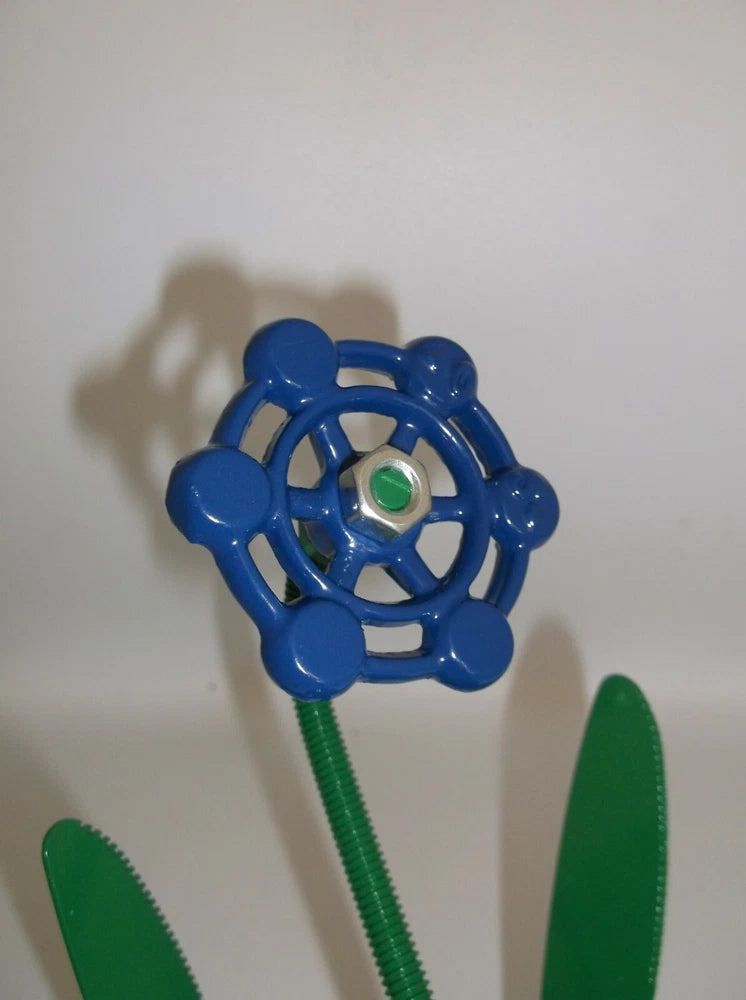 Blue metal flower ornament with green stem and small green center