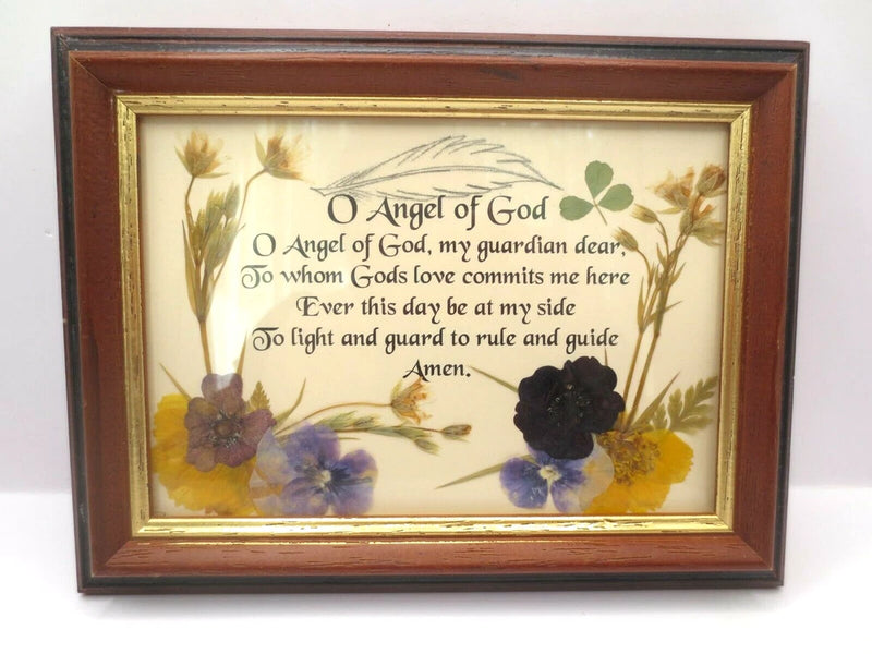 Framed pressed-flower verse artwork with dried blooms and scripture text