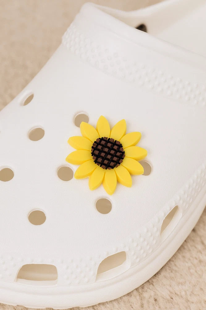 White shoe with yellow sunflower charm accessory