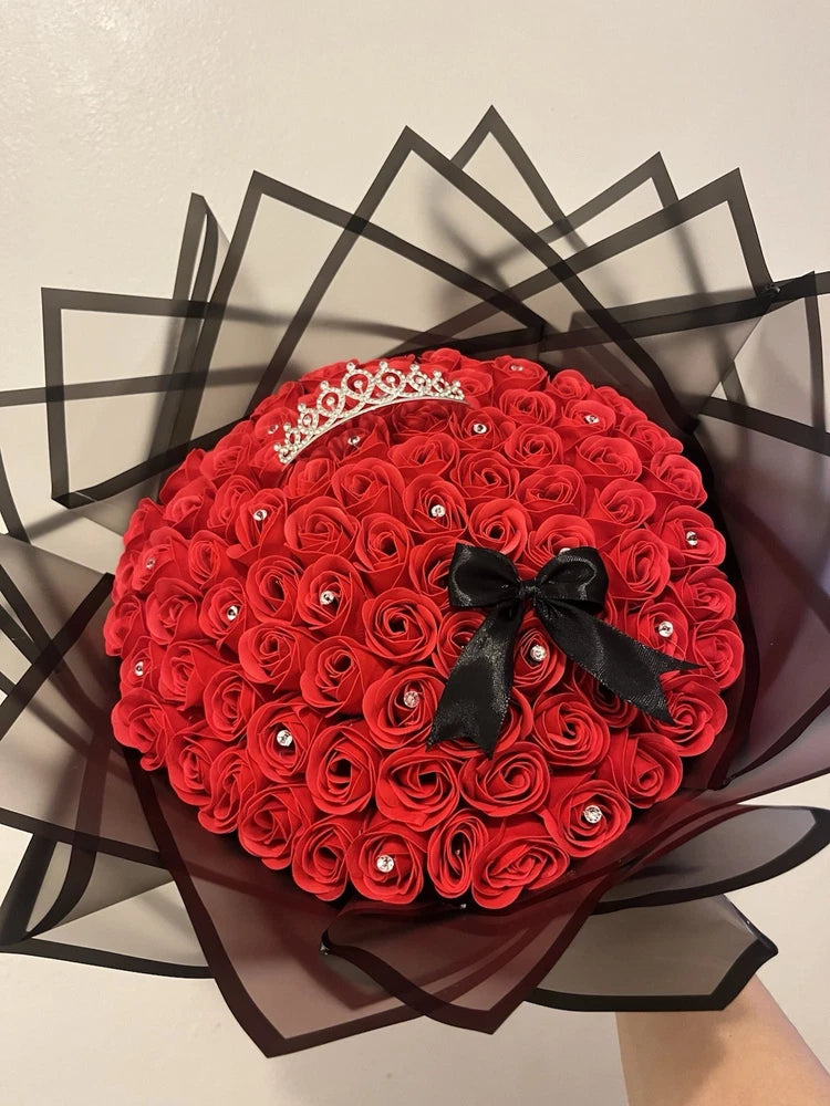 Red rose flower arrangement with crown and black ribbon bow